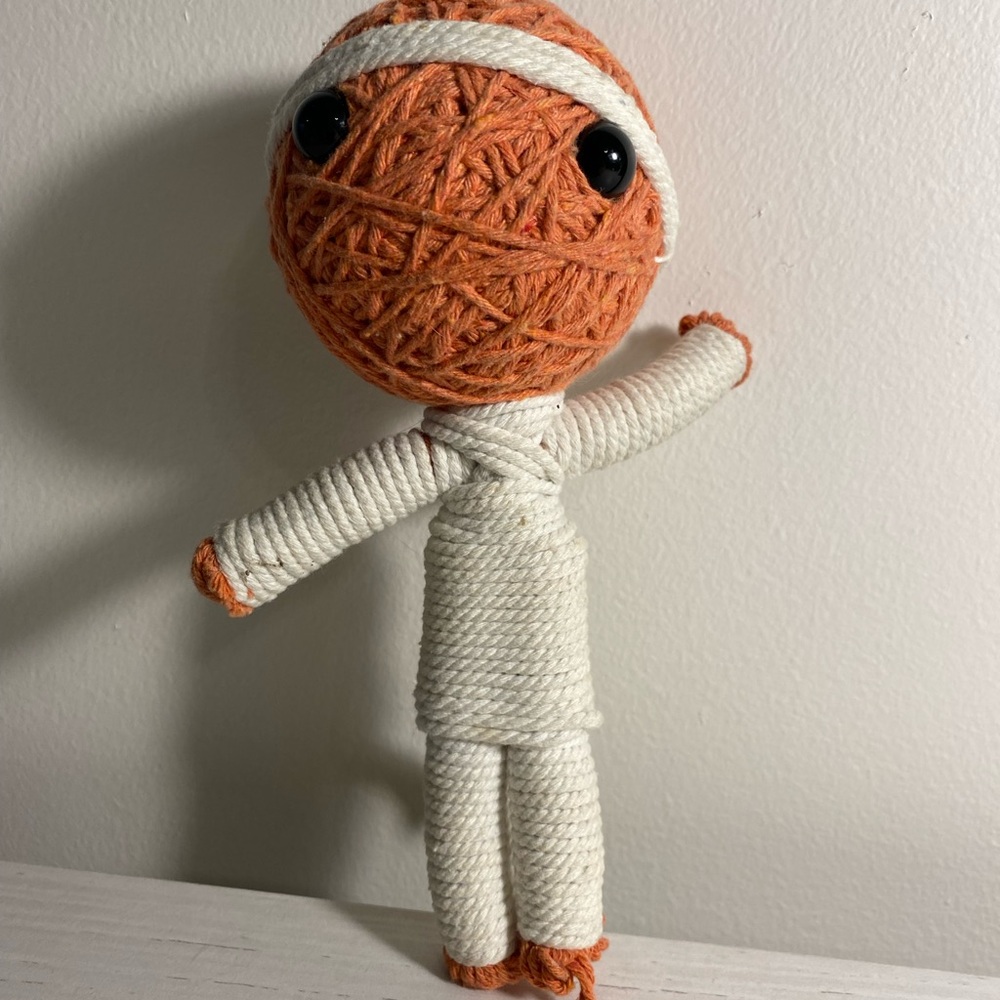 Cute Voodoo doll.  White and orange yarn.